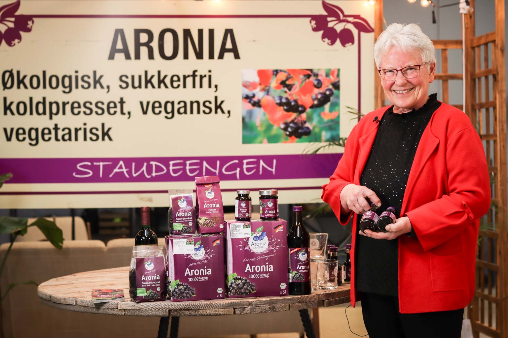 Kvinde præsenterer økologiske aronia produkter